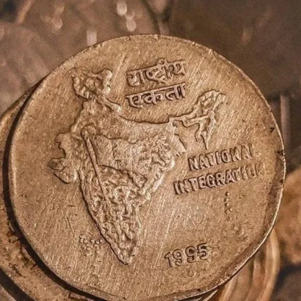 Indian coin embossed with the map of India and the words National Integration